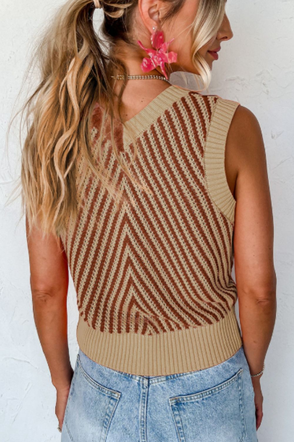 Chevron knit vest in brown and tan with a V-neck and ribbed hem.