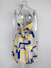 Abstract print halter mini dress with tiered ruffles and a tie back in yellow, blue, and tan.