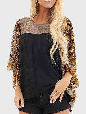 Black blouse with textured panel and floral flutter sleeves