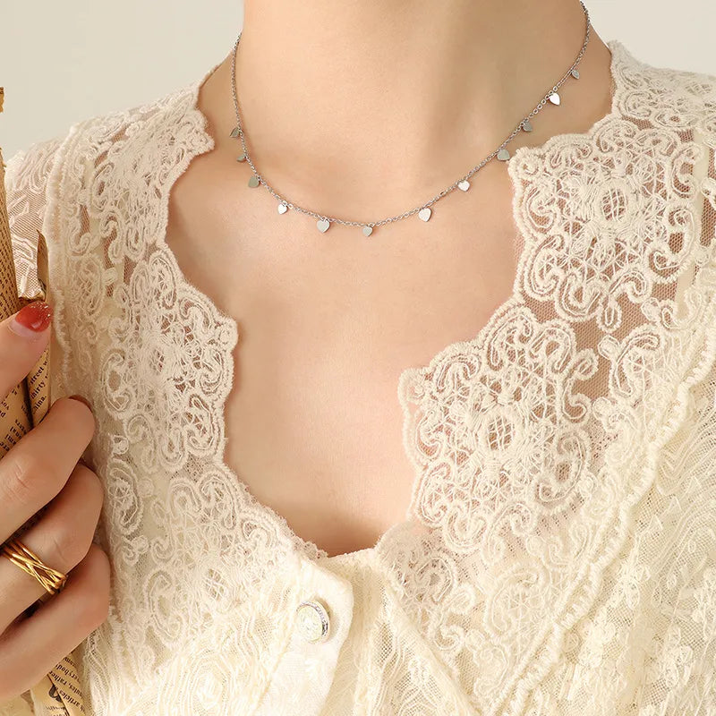 Silver heart charm chain necklace with delicate dangling hearts
