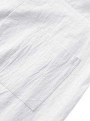 White sweatpants with a textured fabric and a single patch pocket detail.