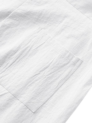White sweatpants with a textured fabric and a single patch pocket detail.