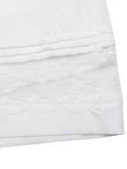 White embroidered lace trim pocketed shorts with pintuck detail.