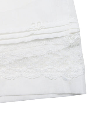 White embroidered lace trim pocketed shorts with pintuck detail.
