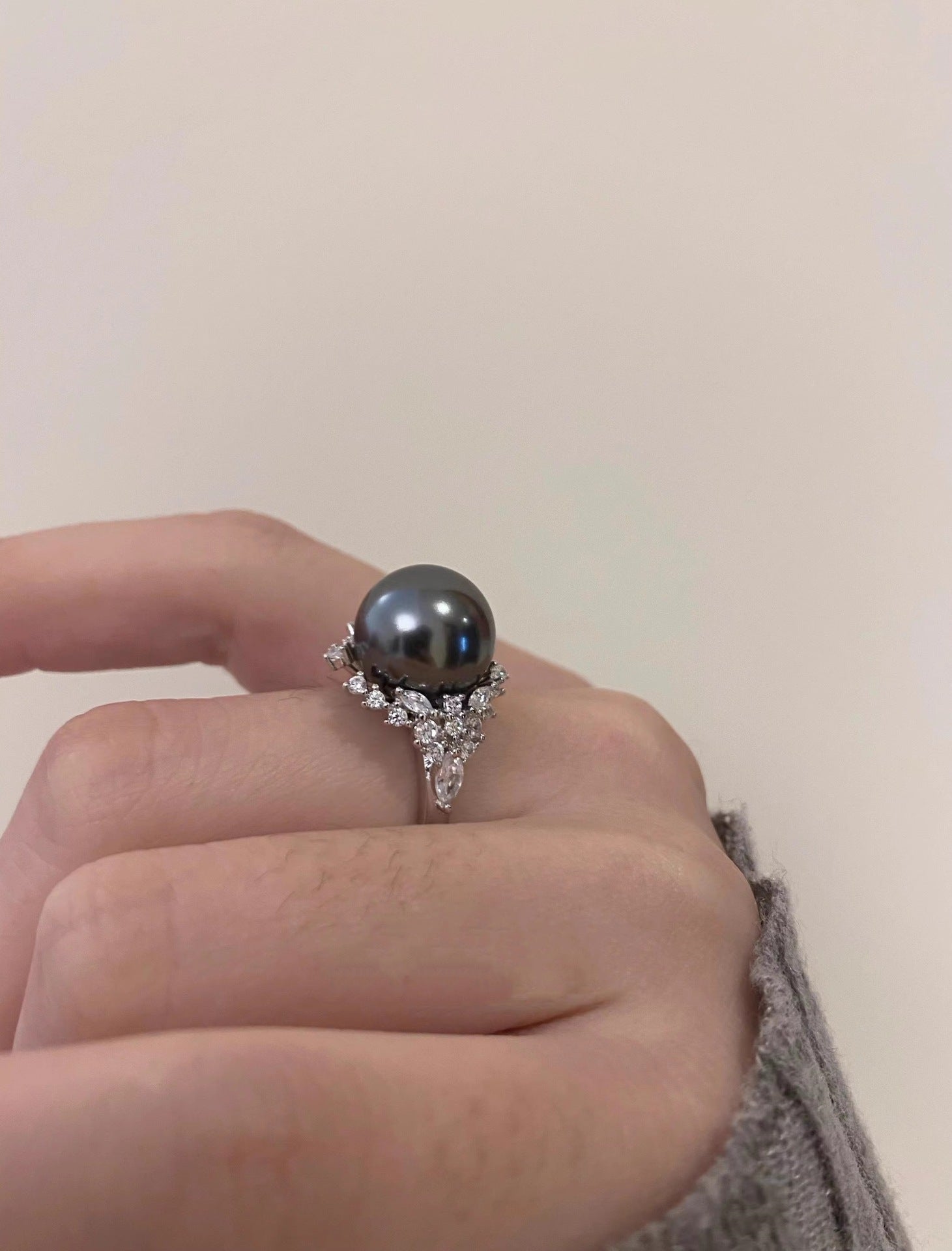 Luminous gray pearl and silver ring with diamond accents.