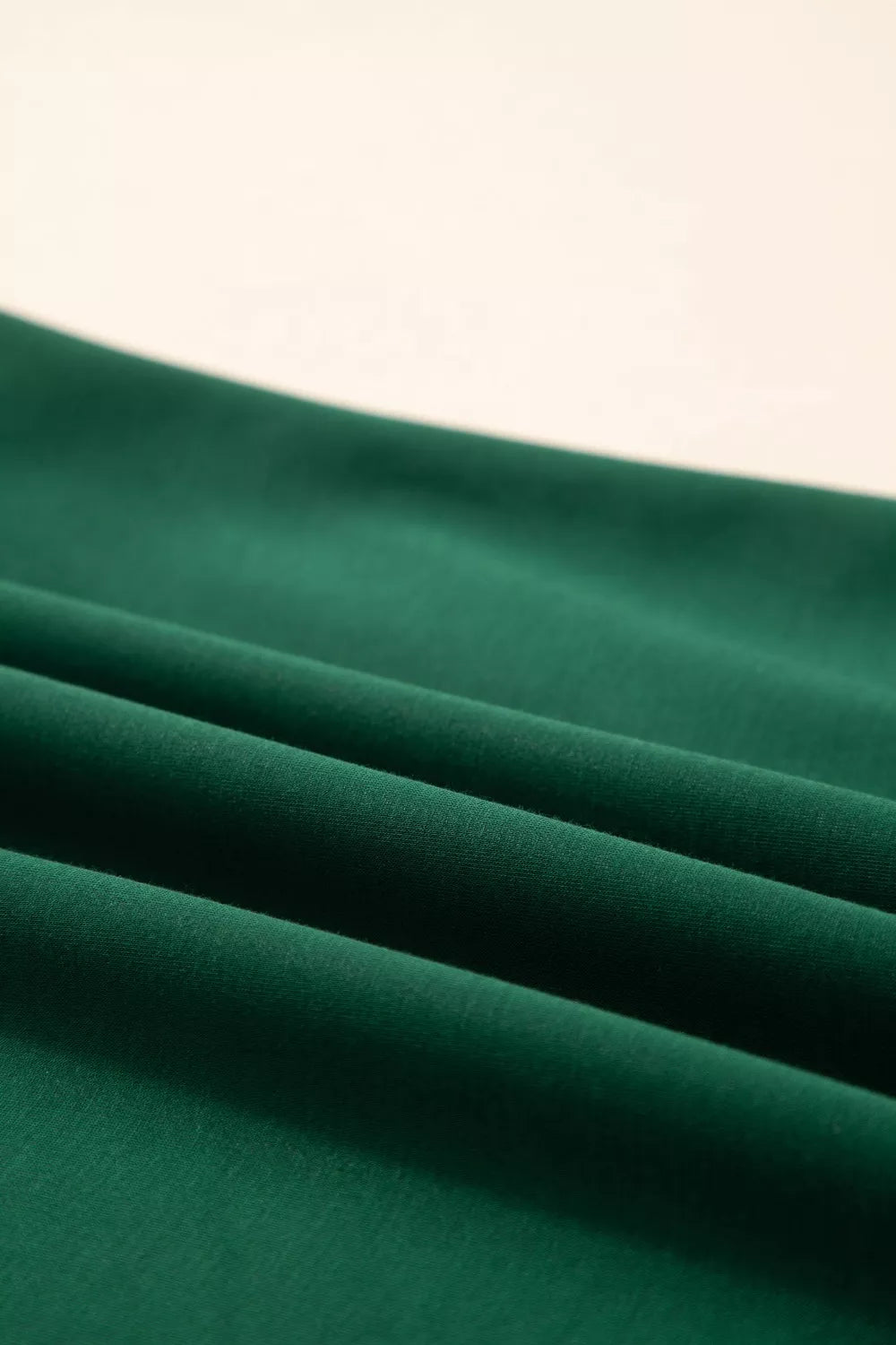 Green polyester t-shirt with relaxed fit and leopard accent detail.