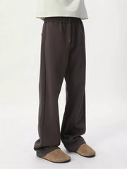 Relaxed fit dark gray sweatpants with adjustable drawstring waist and side pockets.