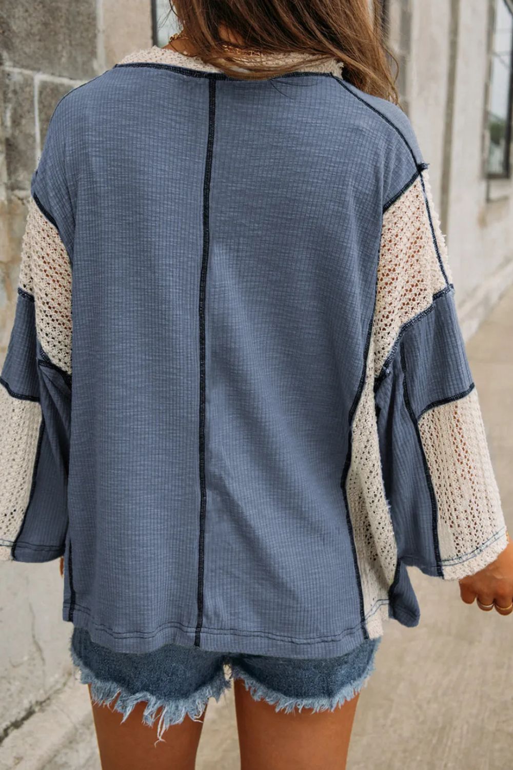 Textured patchwork tunic in Dusty Blue with crochet sleeves and V-neck.