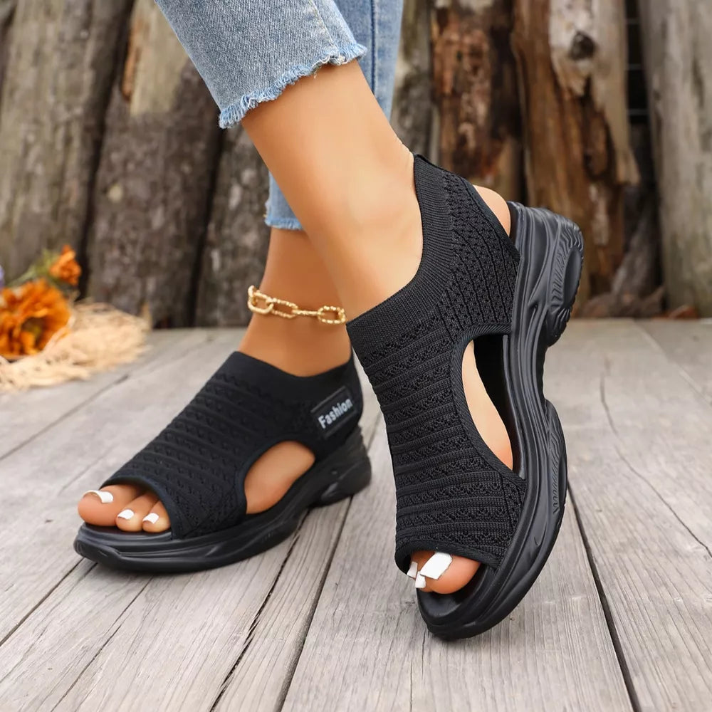 Black sporty chunky platform sandals with breathable knit upper and open toe.