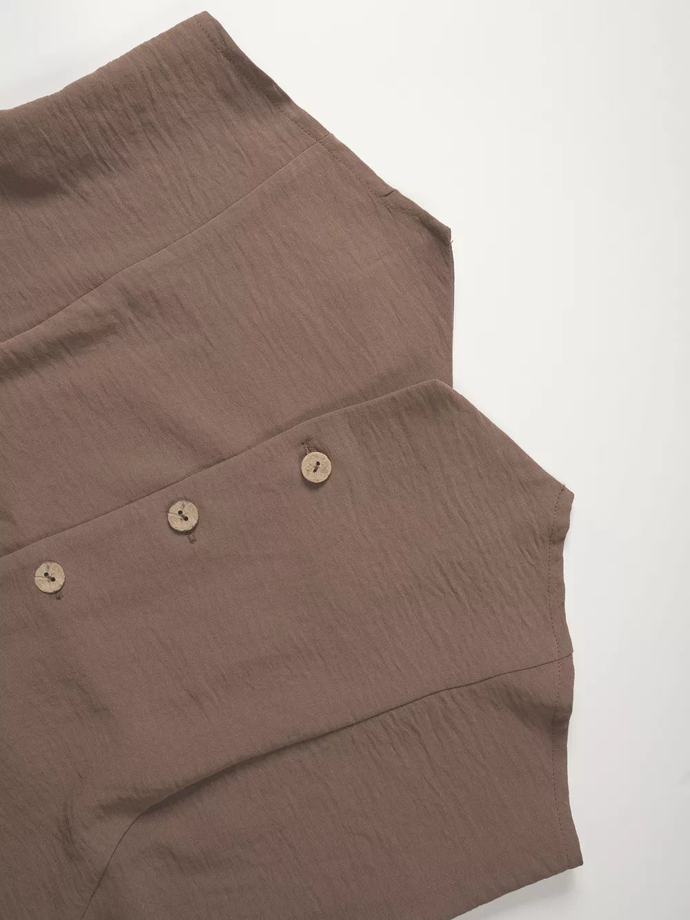 Taupe cropped vest with button details and wide-leg pants ensemble