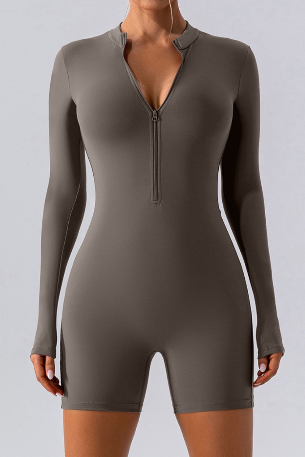 Sculpted performance romper in Caramel with zip detail and long sleeves.