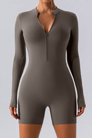 Sculpted performance romper in Caramel with zip detail and long sleeves.