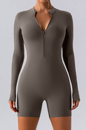 Sculpted performance romper in Caramel with zip detail and long sleeves.