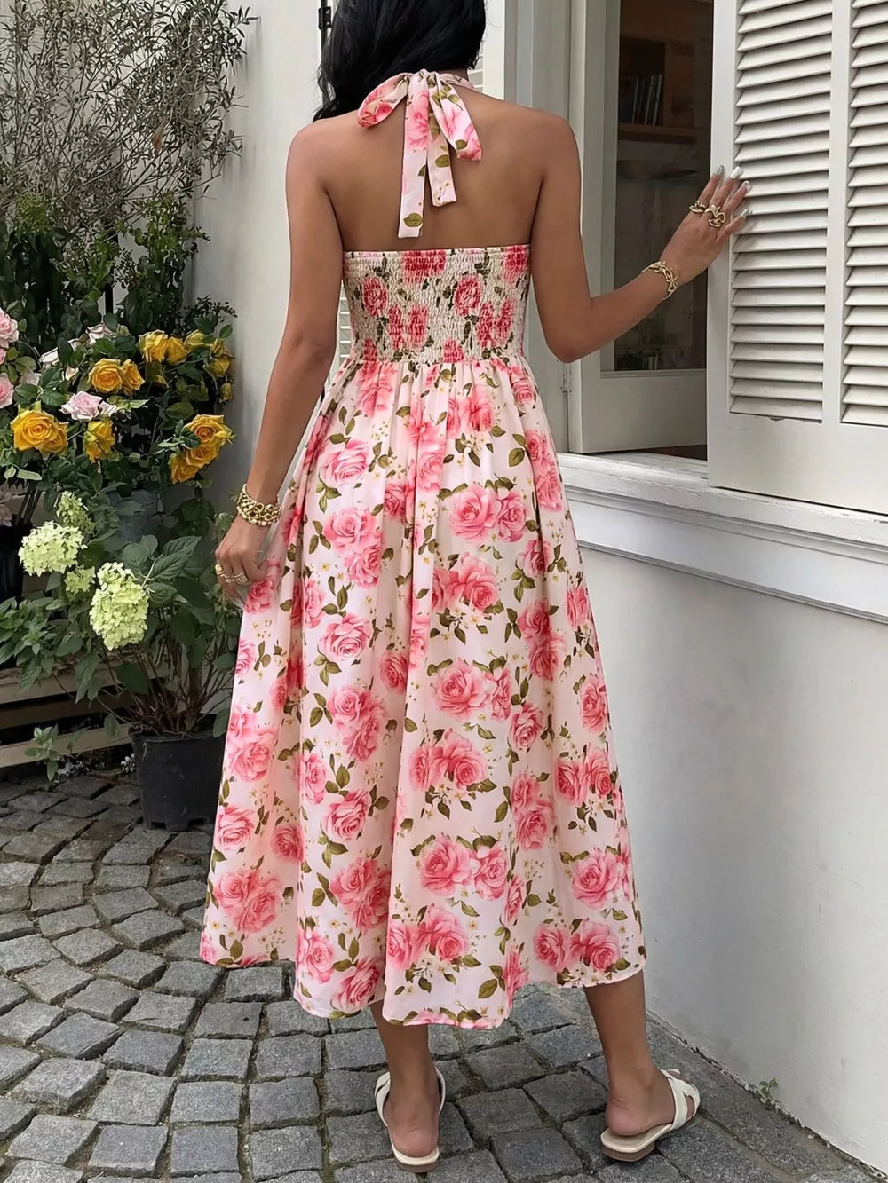 Pink floral halter midi dress with smocked bodice and tie back.