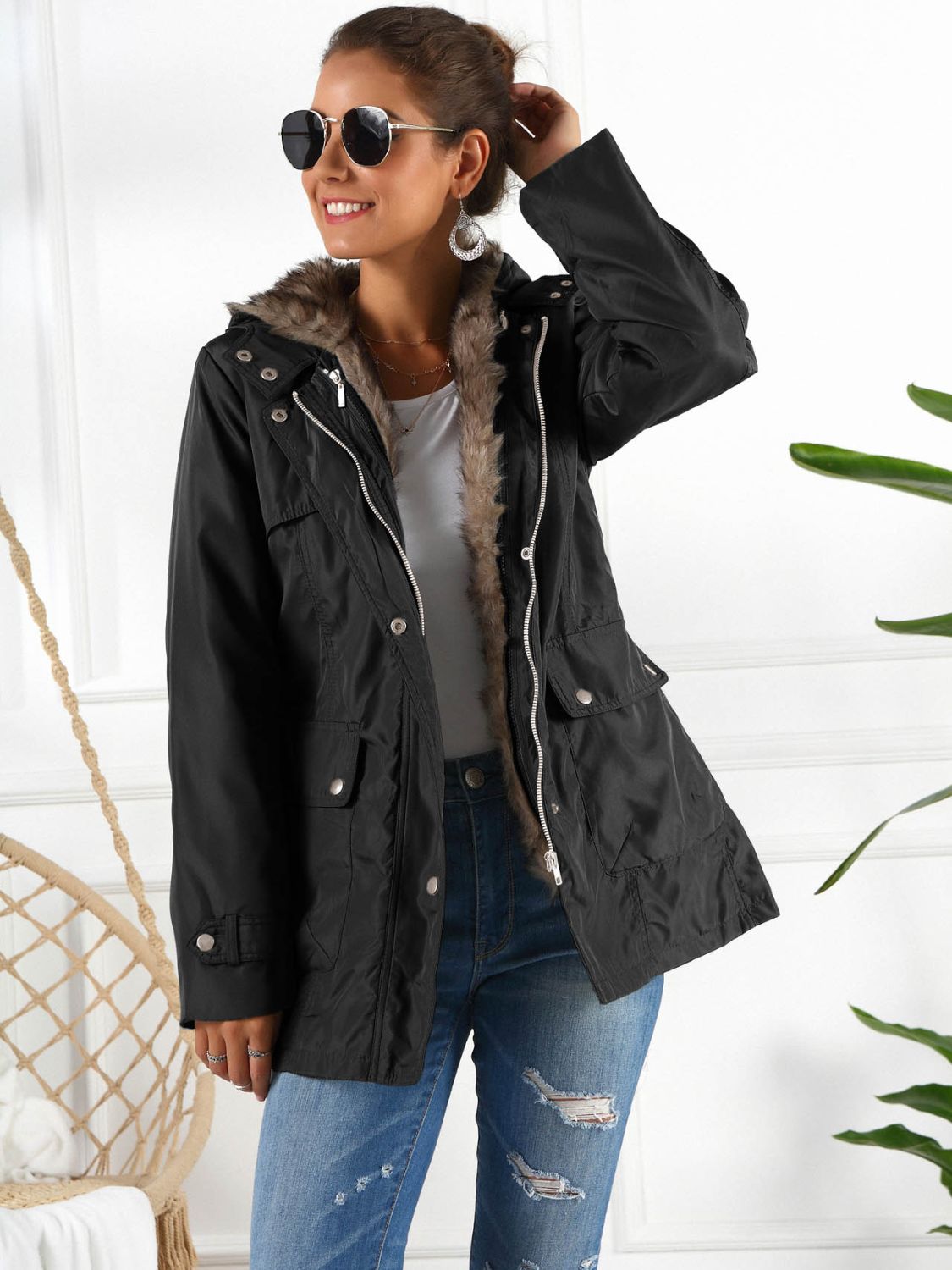 Black belted utility parka with faux fur lining and hood, featuring multiple pockets.