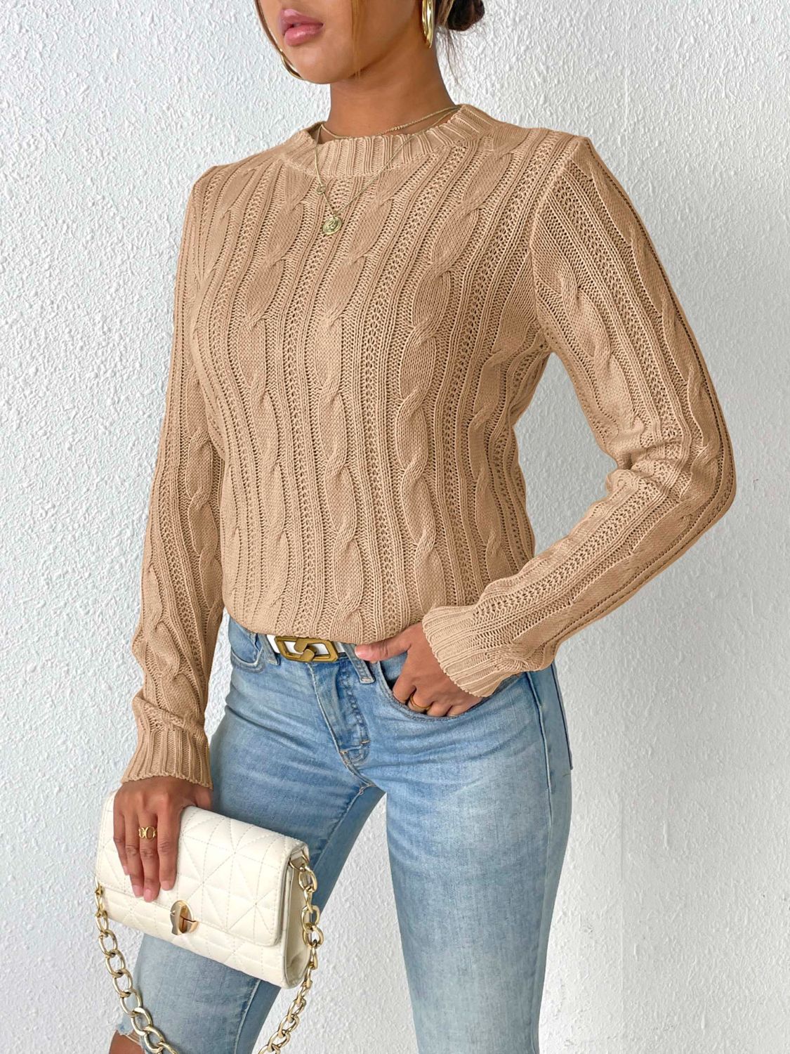 Camel cable knit sweater with mock neck and long sleeves.