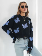 Black cropped knit sweater with distressed butterfly print and frayed hem.