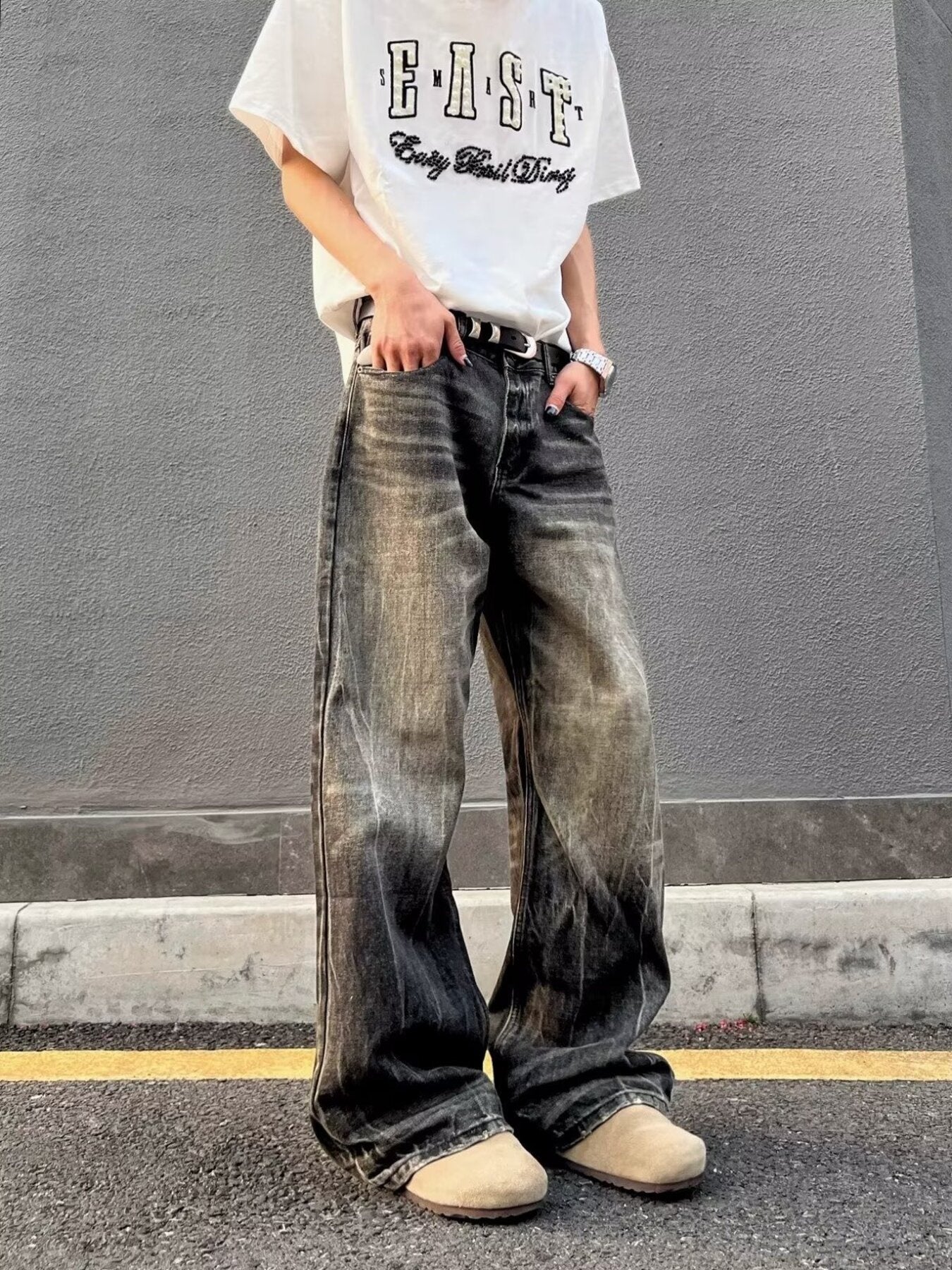 Men's vintage wash wide-leg jeans in relaxed fit, featuring distressed details and a gradient effect.