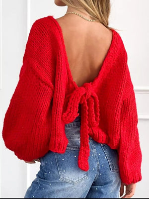 Red tie-front knit cardigan with textured detail and open back.