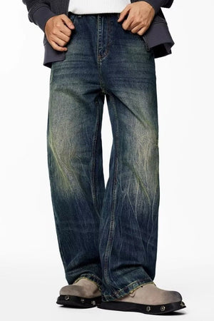 Men's wide-leg jeans in vintage wash blue denim with a relaxed fit.
