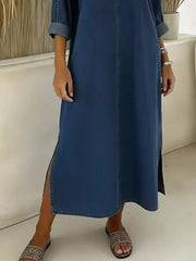 Dark blue denim midi dress with V-neck, cuffed sleeves, and high side slits.