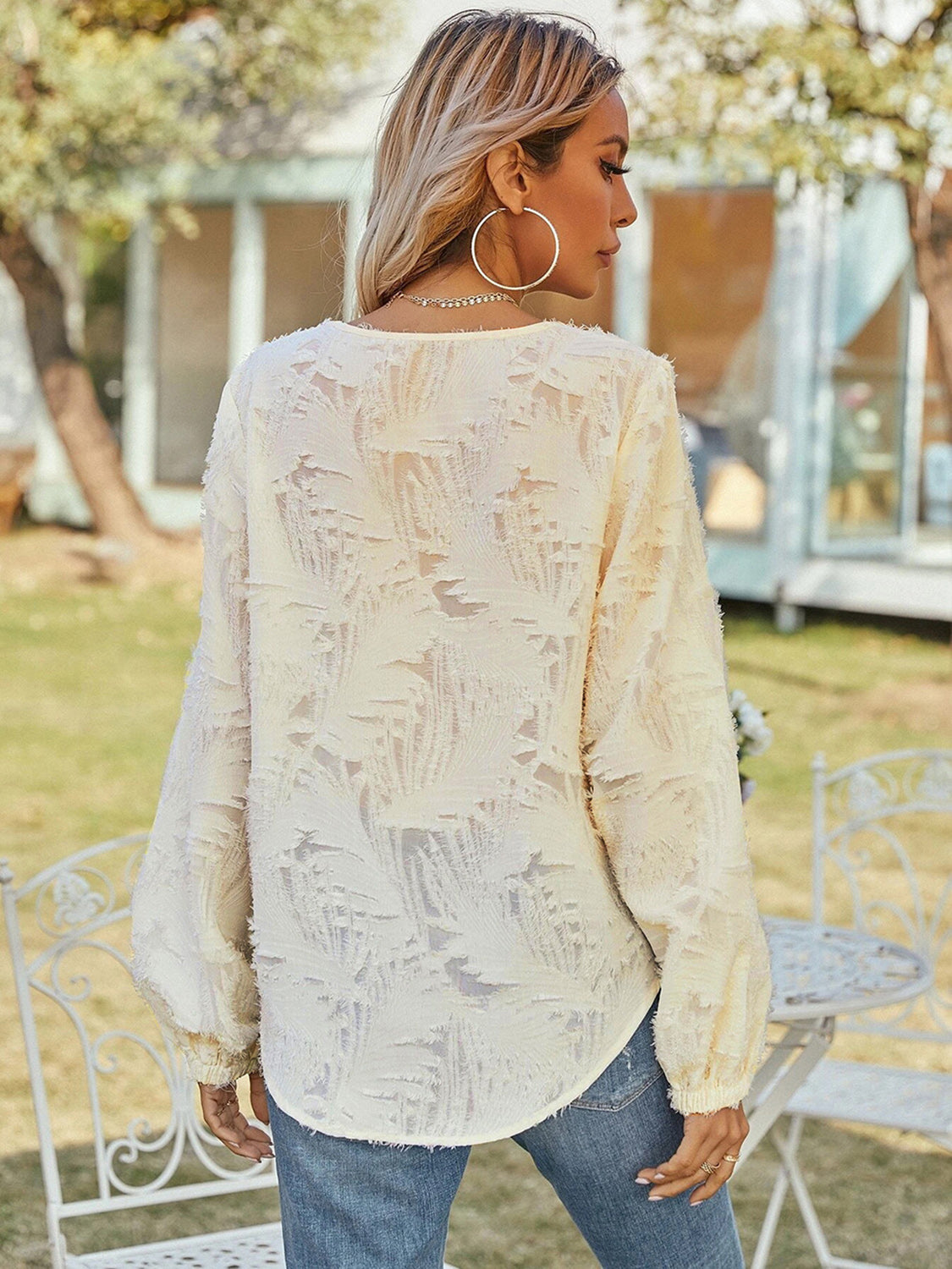 Cream textured puff sleeve v-neck blouse with allover burnout pattern.