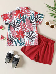 Toddler shirt and shorts set with tropical leaf print and red shorts.