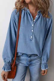 Light blue denim blouse with ruffled collar, button front, and ruffled cuffs.
