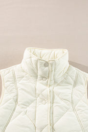 Ivory quilted stand collar vest with snap front closure and diamond pattern.