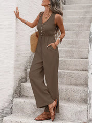 Brown sleeveless wide-leg jumpsuit with V-neck, decorative buttons, and tied waist.