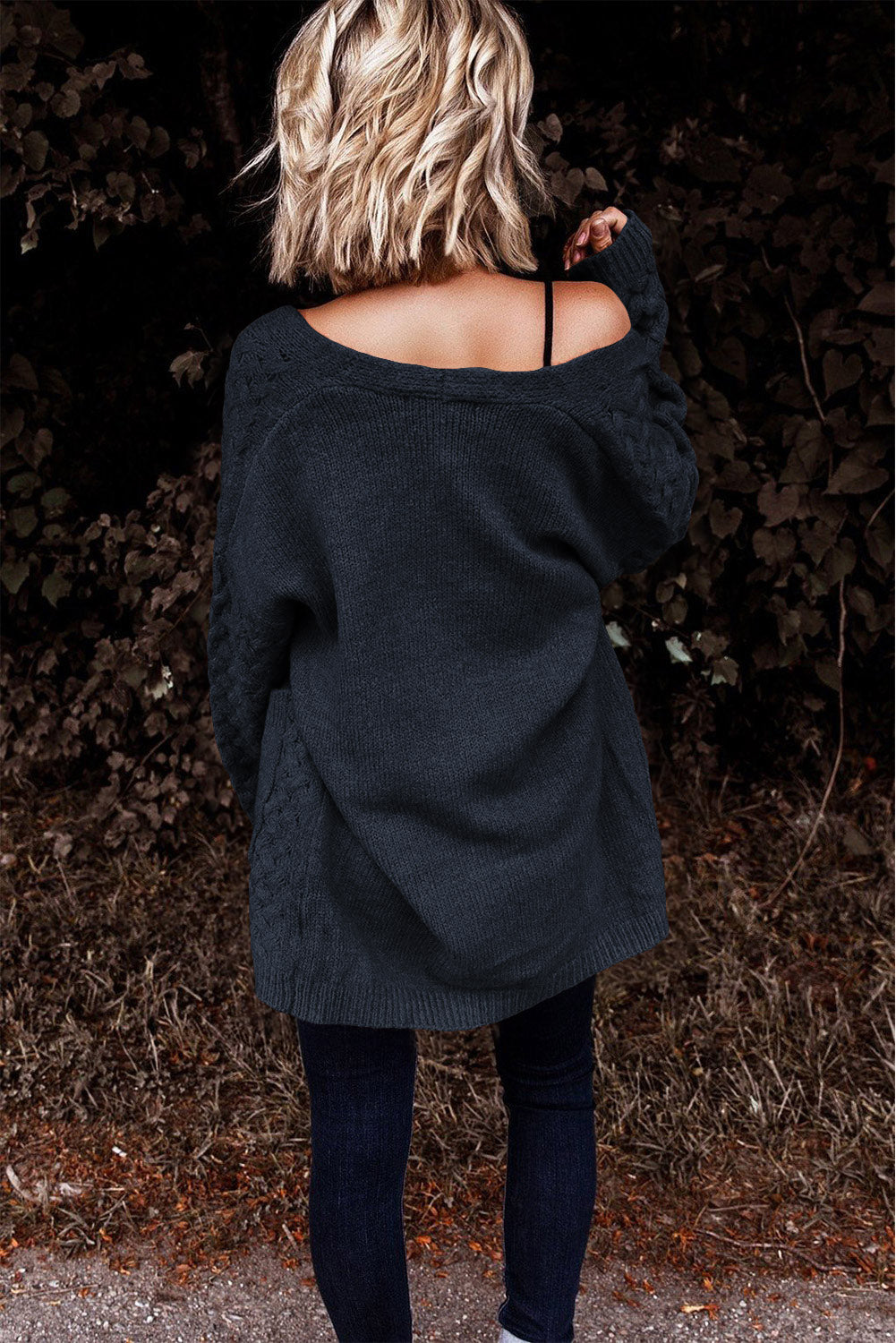 Dark gray open-knit pocket cardigan with cable knit detail on sleeves and sides.