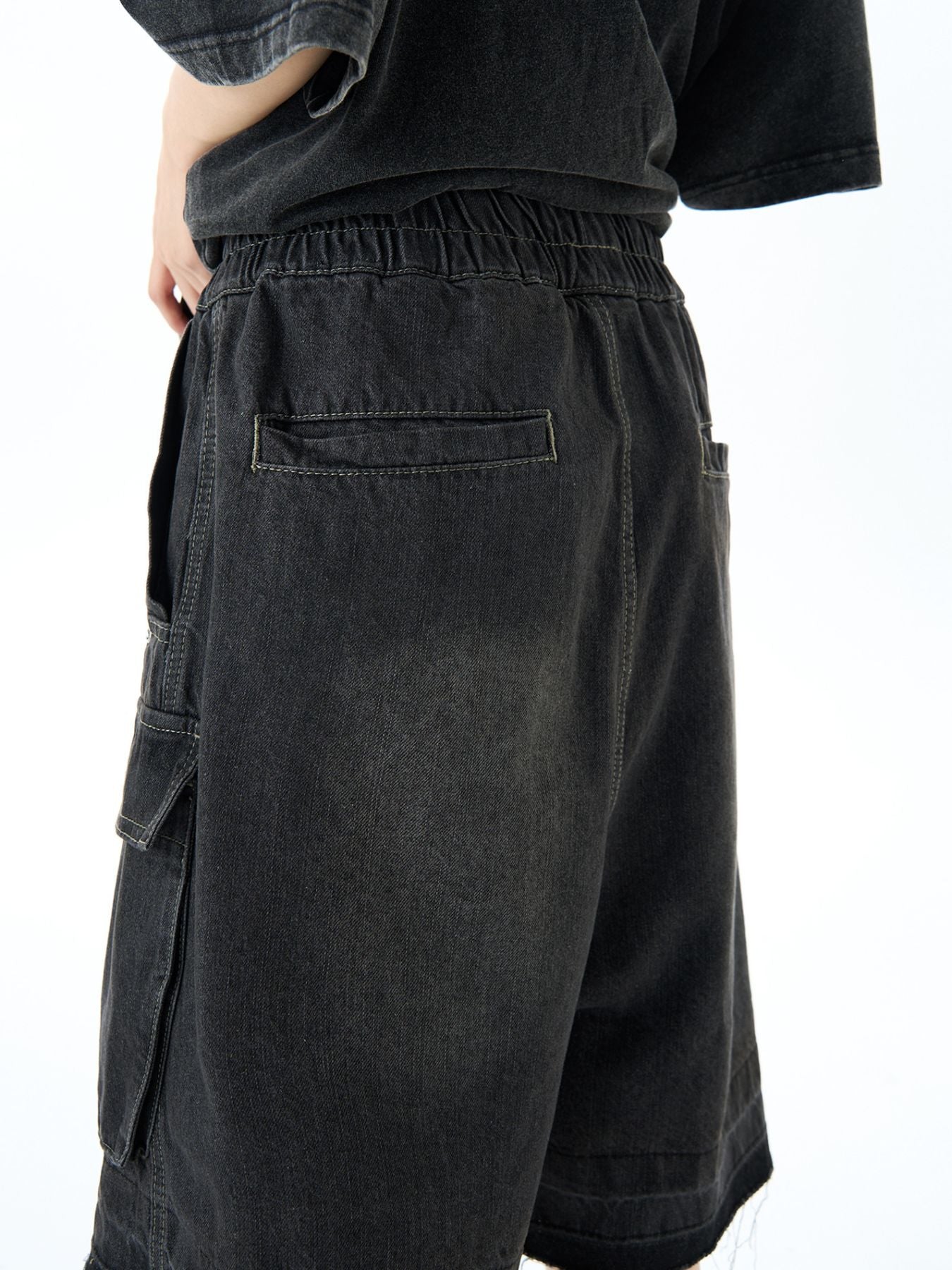Black denim cargo shorts with elastic waist and utility pockets