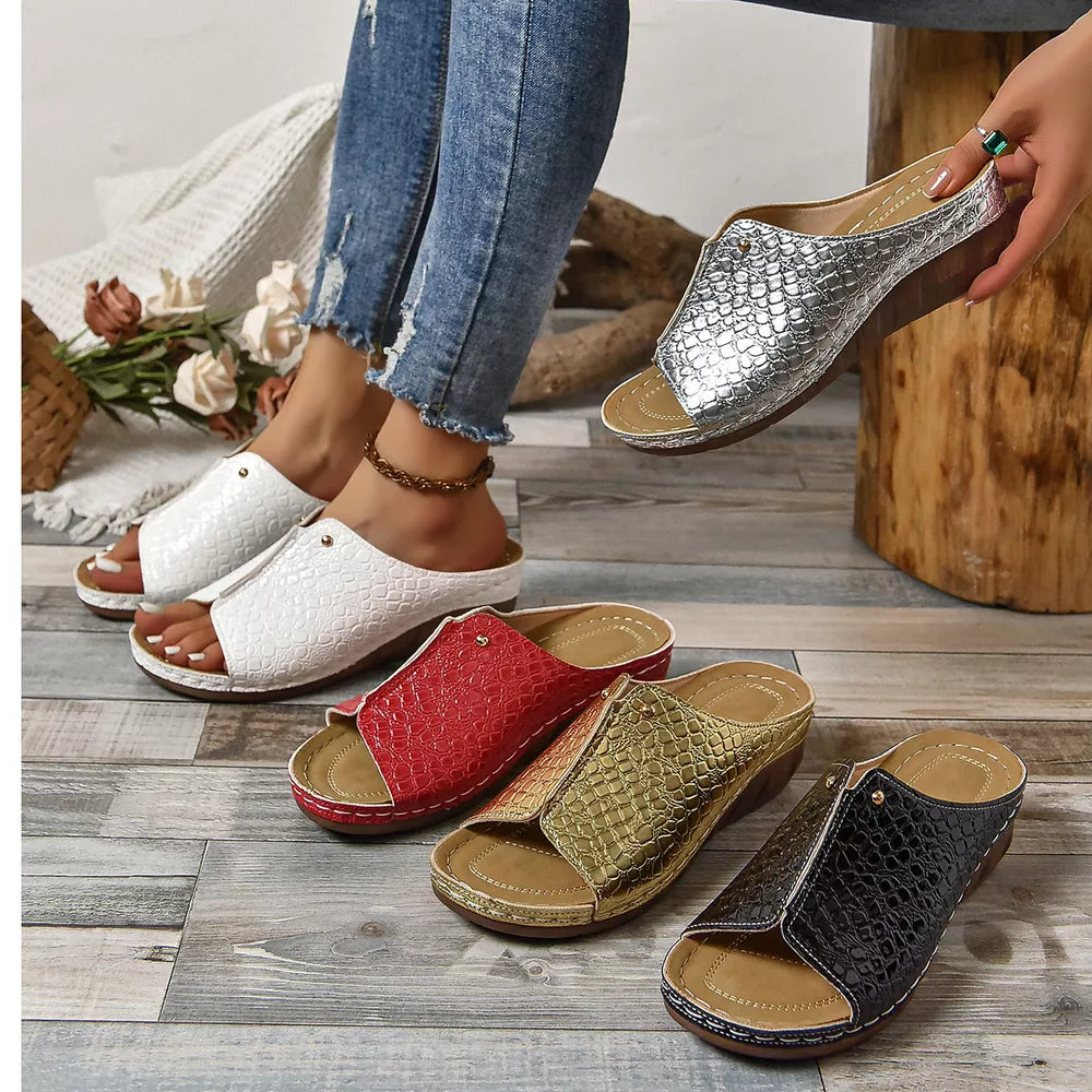 Glossy crocodile-embossed wedge sandals in gold, silver, white, black, and red.