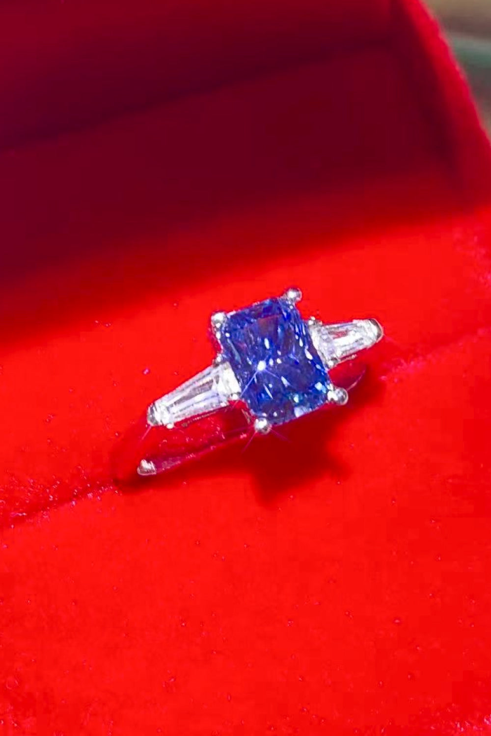 Blue moissanite ring in sterling silver with baguette side stones