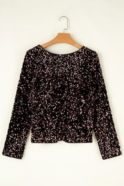 Black sequin backless blouse with long sleeves and a round neckline.