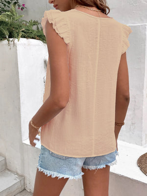 Peach embroidered trim flutter sleeve blouse with textured fabric.