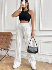 Pleated wide-leg lounge trousers in white with a drawstring waist and a relaxed fit.