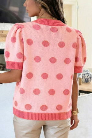 Pink polka dot knit top with puff sleeves and ribbed trim.