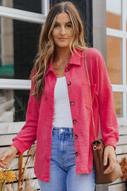 Waffle-knit oversized shirt jacket in strawberry pink with button-down front and collar.
