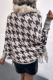 Houndstooth faux fur collar poncho with fringe hem and grey sleeves.