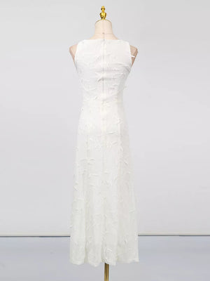 White midi dress with floral applique, sleeveless, boat neck, and a-line cut.