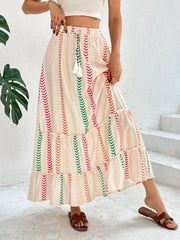 Chevron stripe tiered maxi skirt with drawstring waist and tassel detail.
