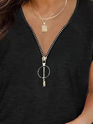 Black zip-front tee with cap sleeves and ruched detail.