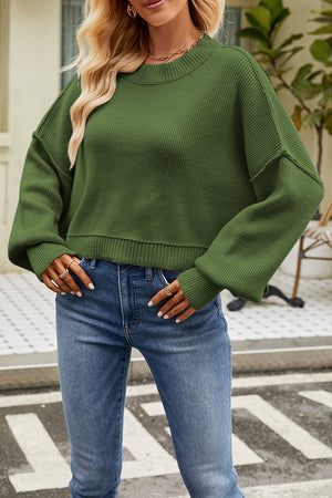 Boxy ribbed knit sweater in dark green with crew neck and relaxed fit.
