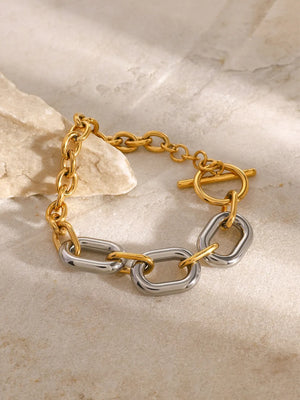 Two-tone gold and silver chain link bracelet with toggle clasp.