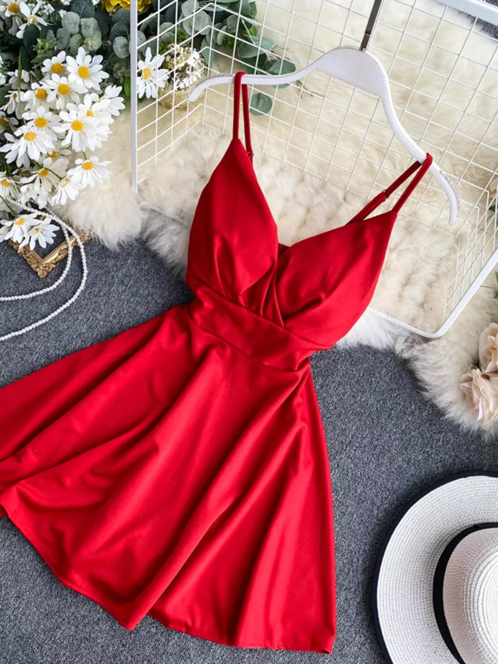 Red V-neck spaghetti strap mini dress with adjustable straps and a flowy skirt.