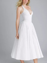 White halter neck midi dress with deep V-neck and full skirt.