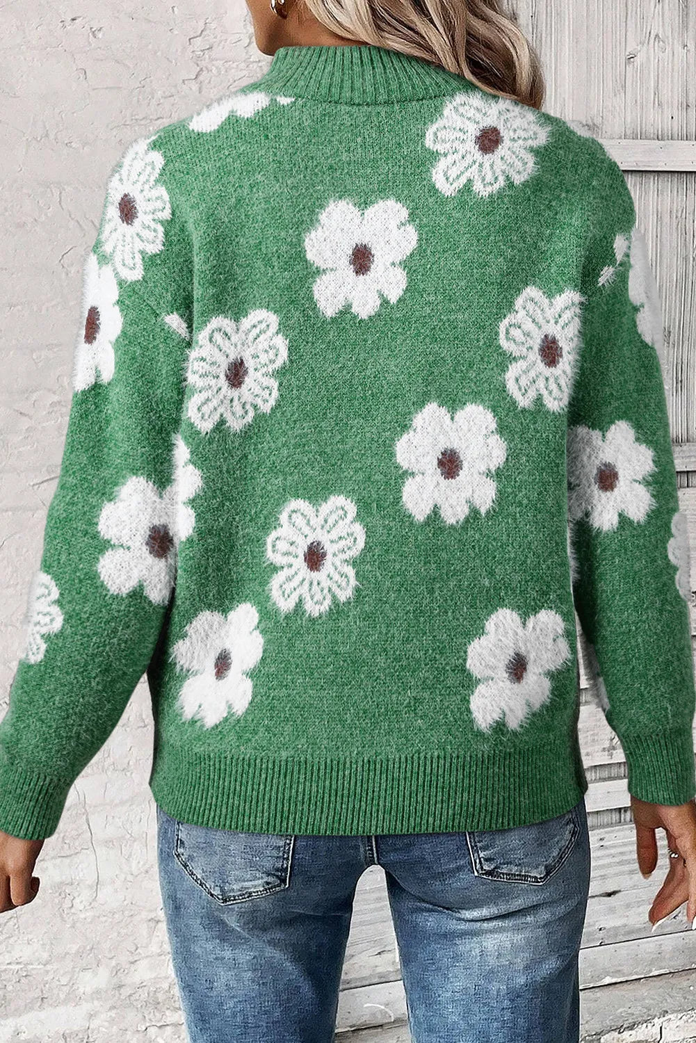Green acrylic mock neck sweater with white floral intarsia pattern and ribbed cuffs and hem.