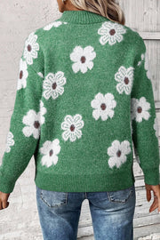 Green acrylic mock neck sweater with white floral intarsia pattern and ribbed cuffs and hem.