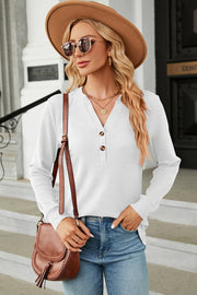 White waffle knit henley shirt with button placket and long sleeves.